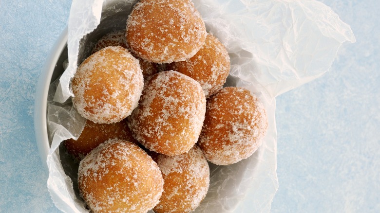Sugar donut holes in a white bowl