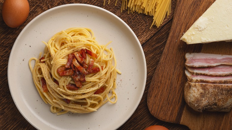 carbonara and ingredients on table