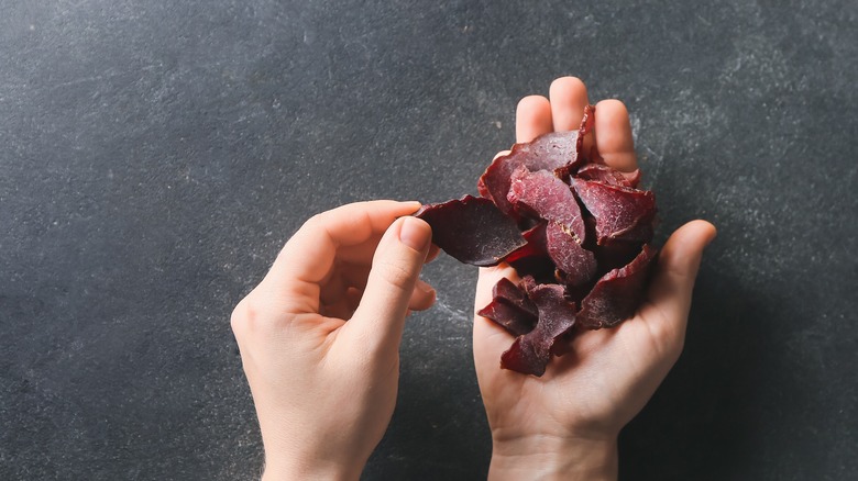jerky meat in hand