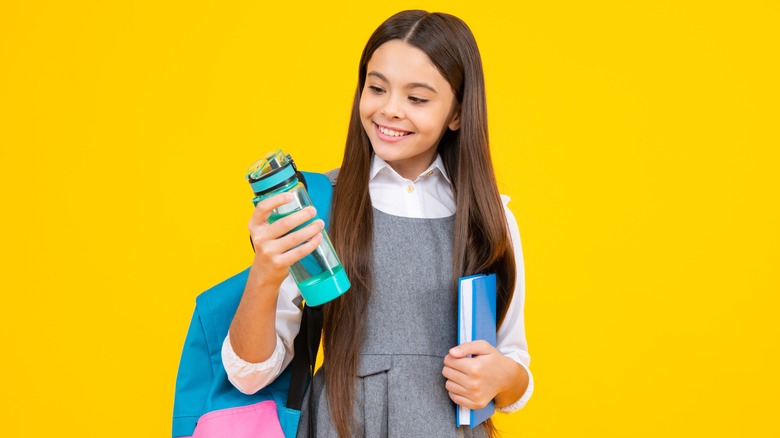 School child holding a water bottle