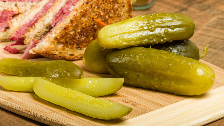 Sliced pickles on a board
