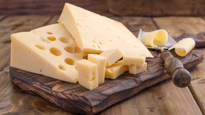 Swiss cheese on cutting board