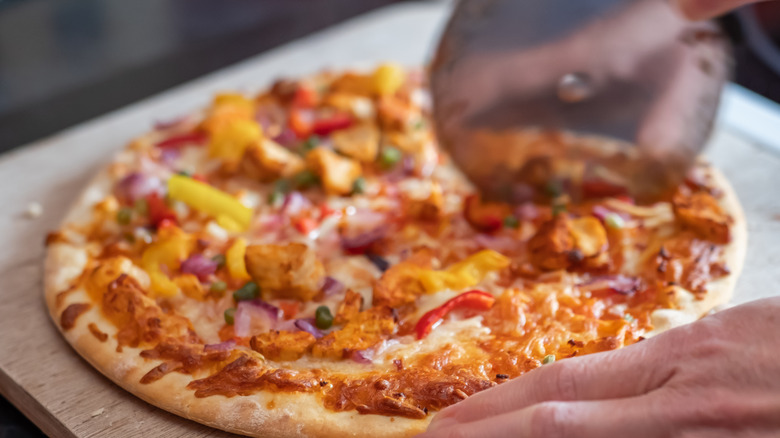 Cutting a pizza with slicer