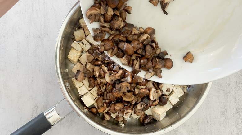 adding mushrooms to skillet