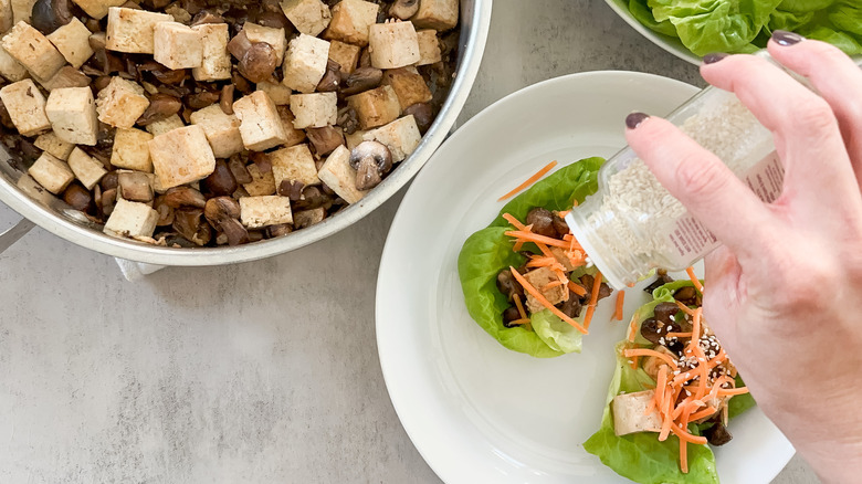 sprinkle sesame seeds on top of lettuce wraps