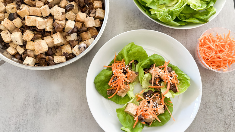 tofu and mushroom lettuce wraps on side of sauteed tofu