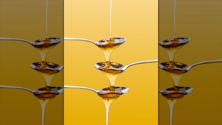 Syrup dripping down three spoons