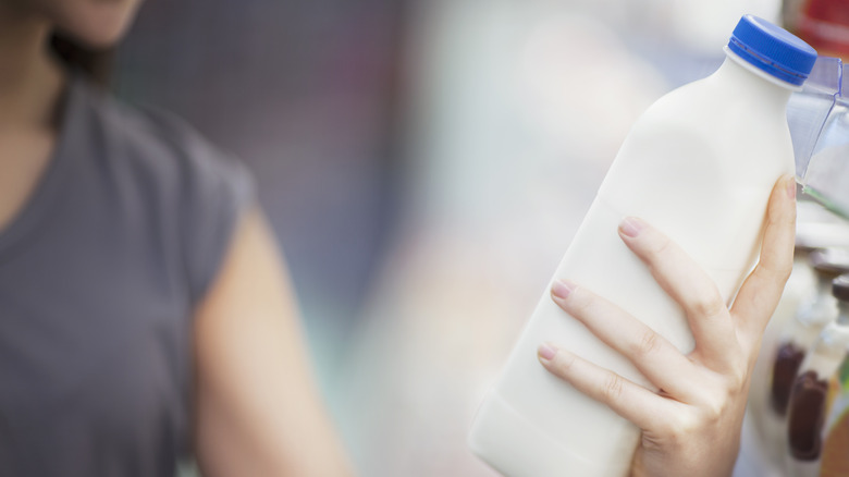 Woman holding bottle of milk