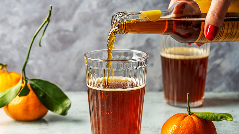hand pouring glass of Chinotto