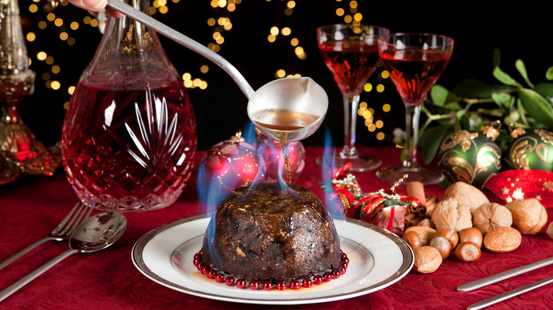 Brandy being poured over flaming Christmas pudding