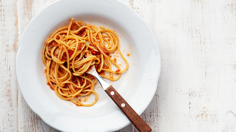 partially eaten spaghetti in white bowl