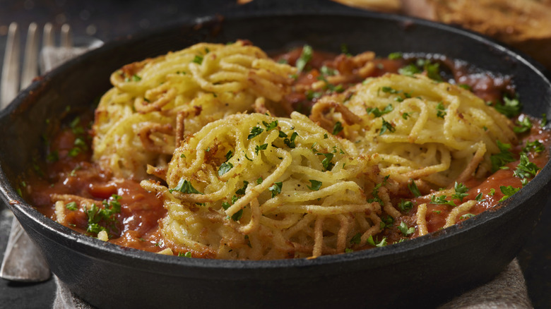 spaghetti fritters in pot with sauce