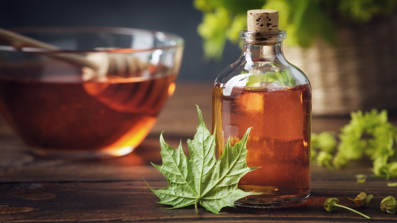 Bottle of maple syrup and maple leaf