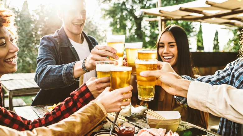 Friends toasting beers at restaurant 