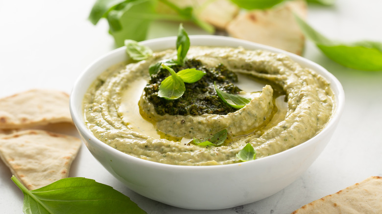 Pesto hummus with pesto drizzled over the top