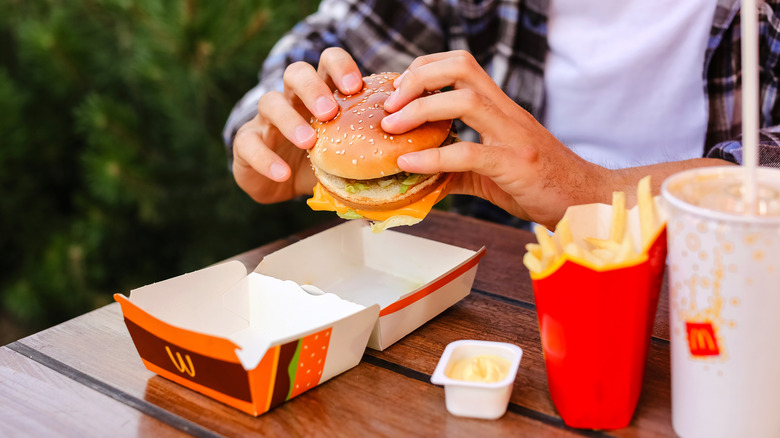Person about to eat a burger with dipping sauce