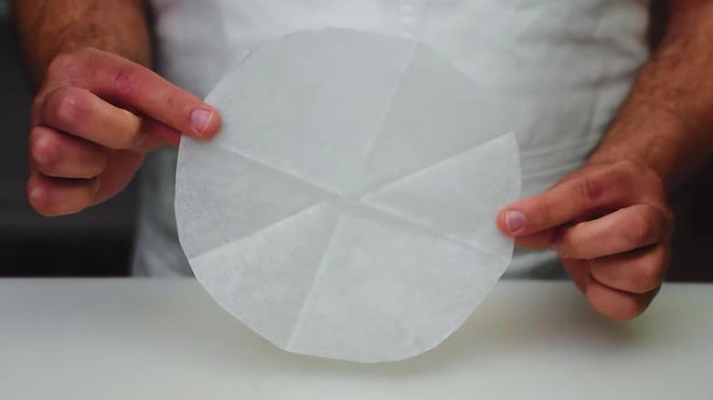 Chef holding cartouche for cooking