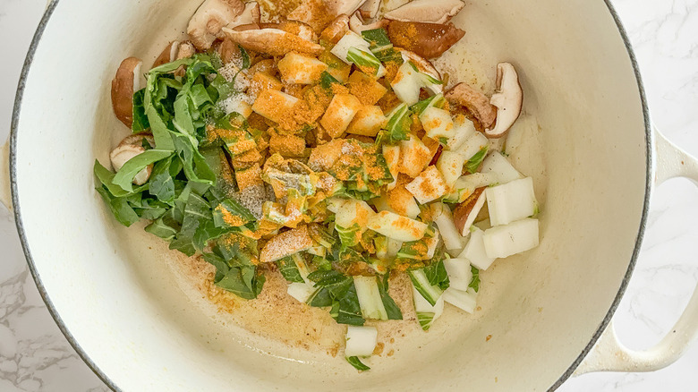veggies and seasoning in stock pot