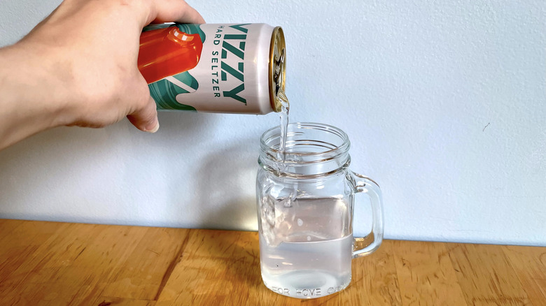 Orange cream pop being poured into cup