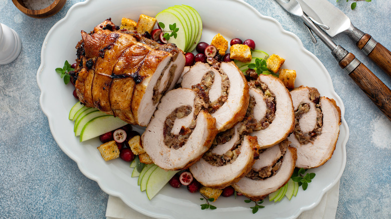roast stuffed pork loin on plate on table