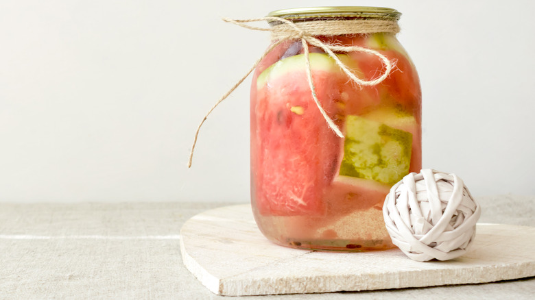 Watermelon fermenting in glass jar