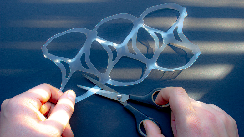 Cutting a plastic six pack ring