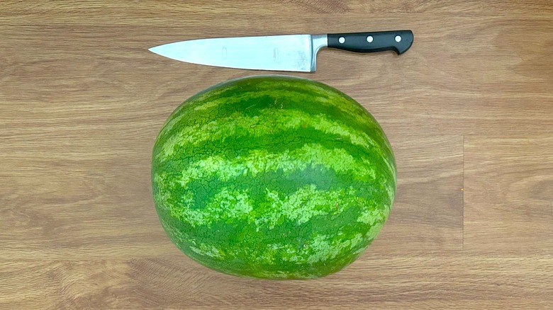 Whole watermelon and chef's knife