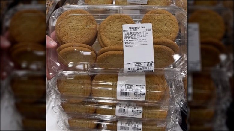 Hand holding a package of 21 brown butter sugar cookies from Costco
