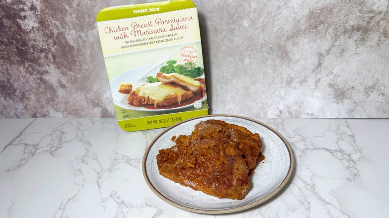 Plate and box of Trader Joe's Chicken Breast Parmigiana with Marinara Sauce