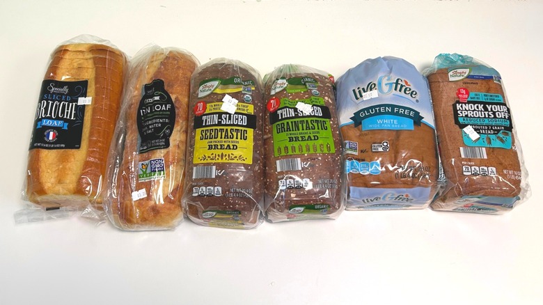 Six loaves of bread from Aldi, lined up next to each other