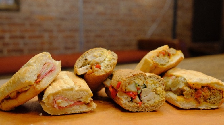 Three sandwiches from Potbelly on a wooden table