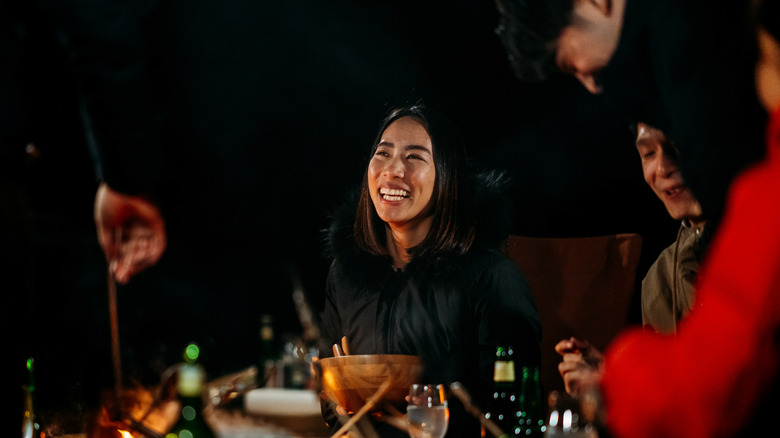 People laughing over dinner
