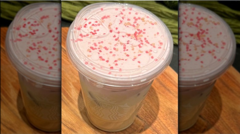 Starbucks' new cherry iced chai on a wood platter