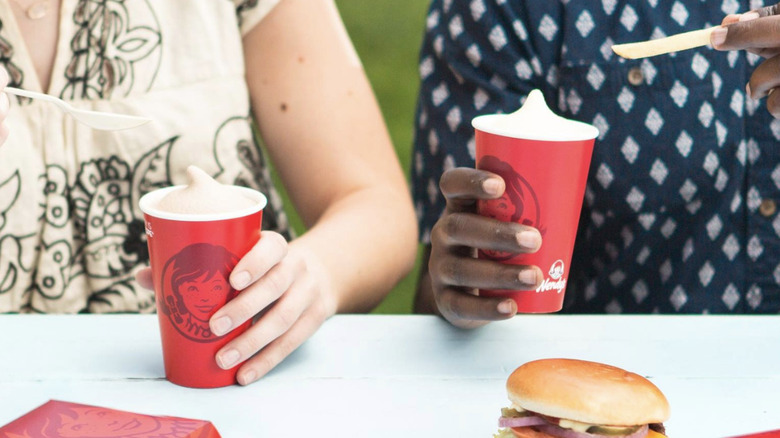People holding Wendy's Frostys