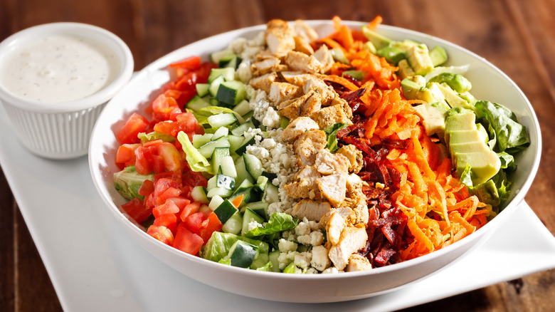 Classic Cobb salad with dressing in ramekin on the side
