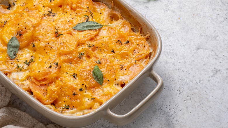scalloped sweet potatoes in baking dish