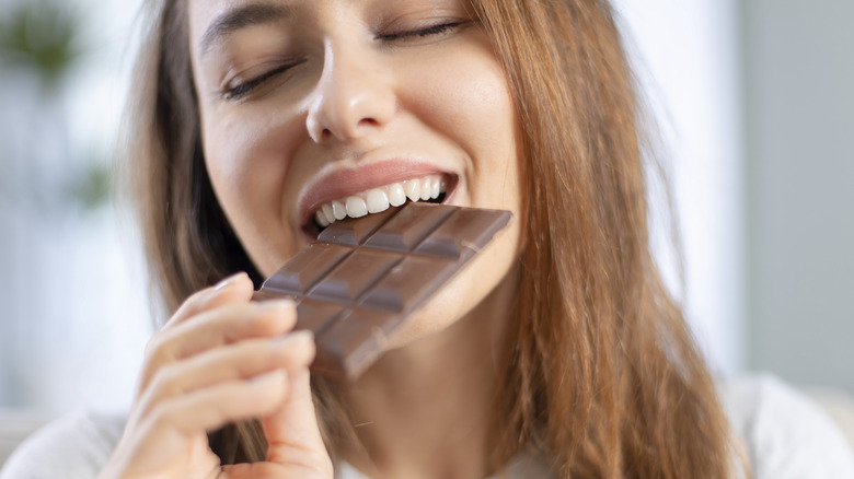 Woman eating candy bar