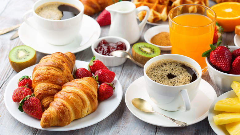 Continental breakfast spread on wooden surface