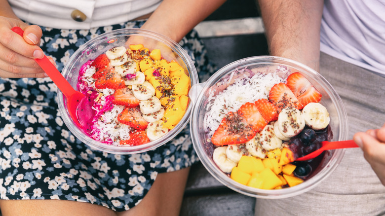 Couple eating acai bowls