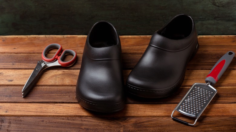 work clogs on wood background