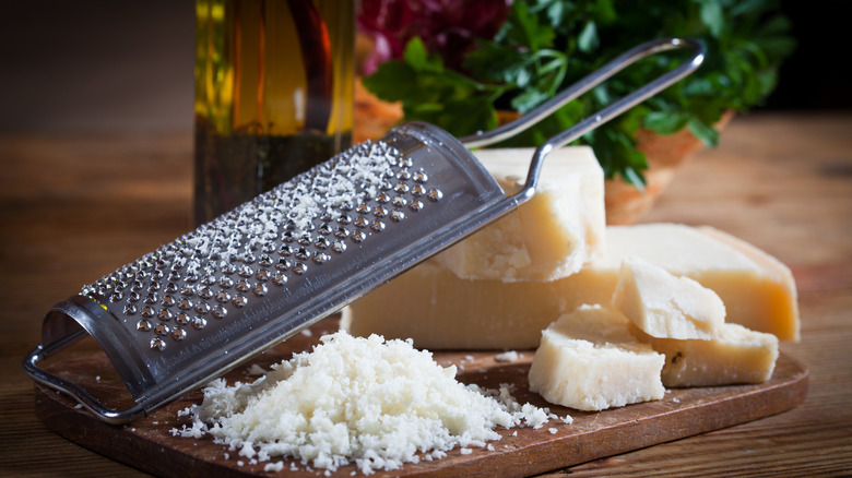 Blocks of cheese and grater