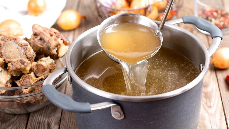 Pot of bone broth with ladle