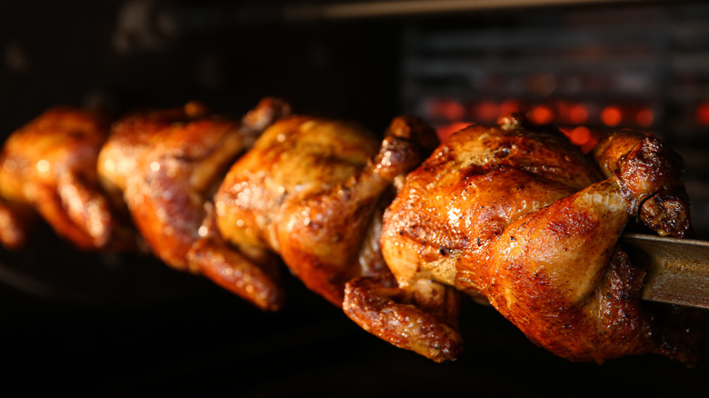 Rotisserie chickens on a skewer
