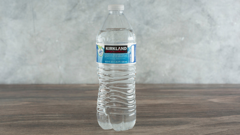 Bottle of Kirkland water on wooden table