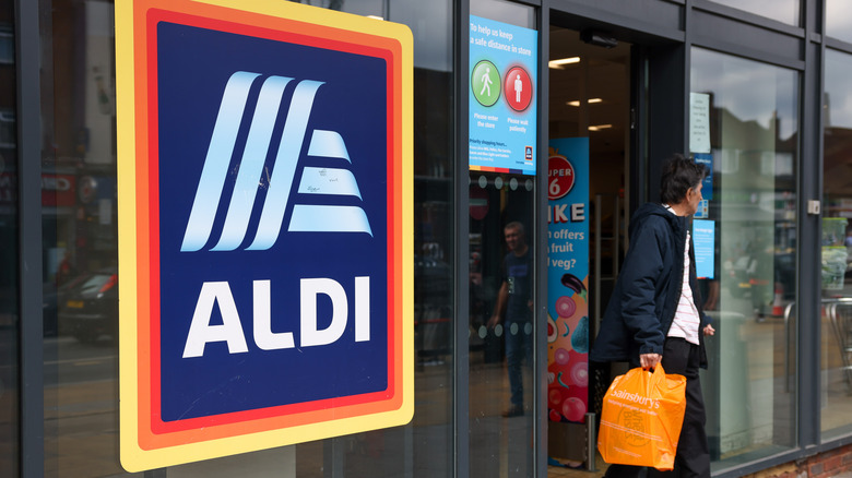 shopper walking out of an aldi