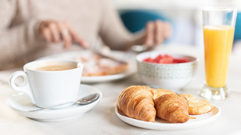 Breakfast table coffee and croissants
