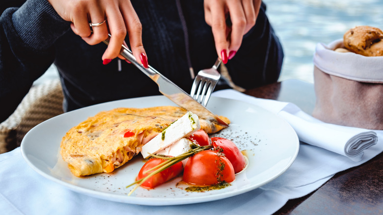 Woman eating an omelet made with egg powder