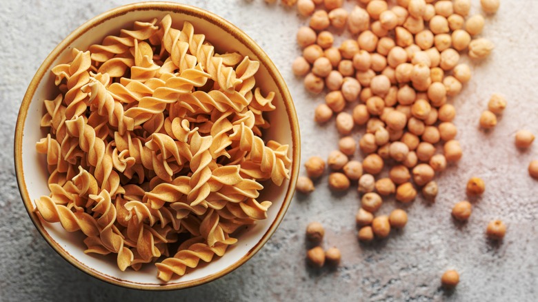 Chickpea fusilli pasta surrounded by garbanzo beans
