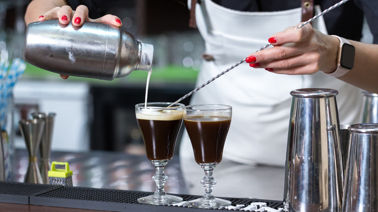 woman adding float to cocktail