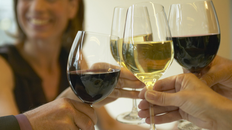 people toasting with glasses of wine